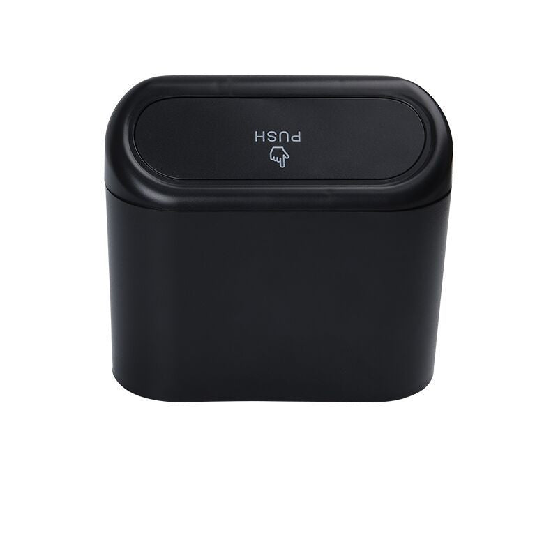 Black trash can with push lid on a white background