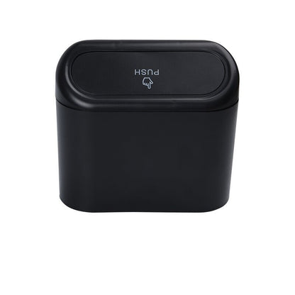 Black trash can with push lid on a white background